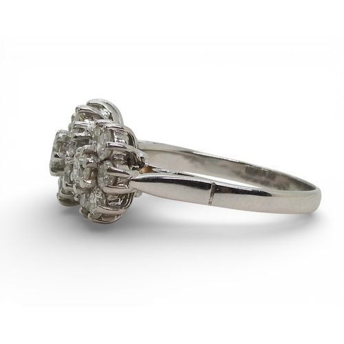 2717 - A RING OF THREE FLOWERSset in 18ct white gold and set with estimated approx 1.60cts of brilliant cut... 