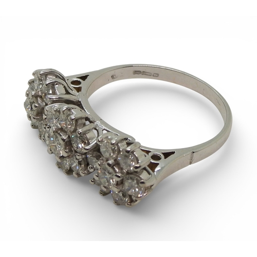 2717 - A RING OF THREE FLOWERSset in 18ct white gold and set with estimated approx 1.60cts of brilliant cut... 