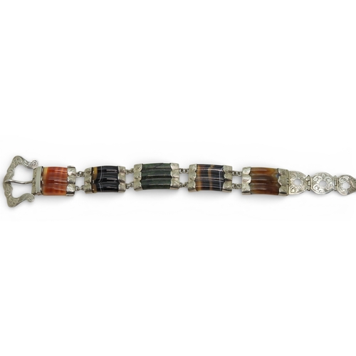 2718 - A SCOTTISH AGATE BRACELETmounted in white metal with a buckle shaped clasp. Total length 22cm, weigh... 