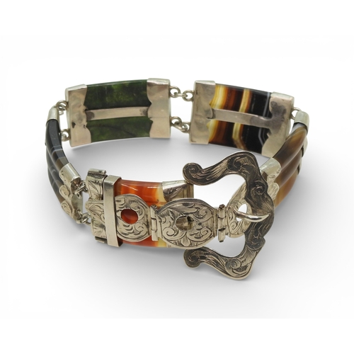 2718 - A SCOTTISH AGATE BRACELETmounted in white metal with a buckle shaped clasp. Total length 22cm, weigh... 