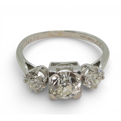 2720 - A THREE STONE DIAMOND RINGthe galleried mount is made in white metal, and set with three old cut dia... 