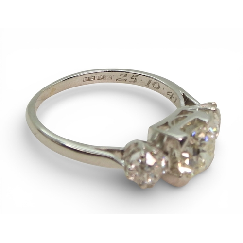 2720 - A THREE STONE DIAMOND RINGthe galleried mount is made in white metal, and set with three old cut dia... 