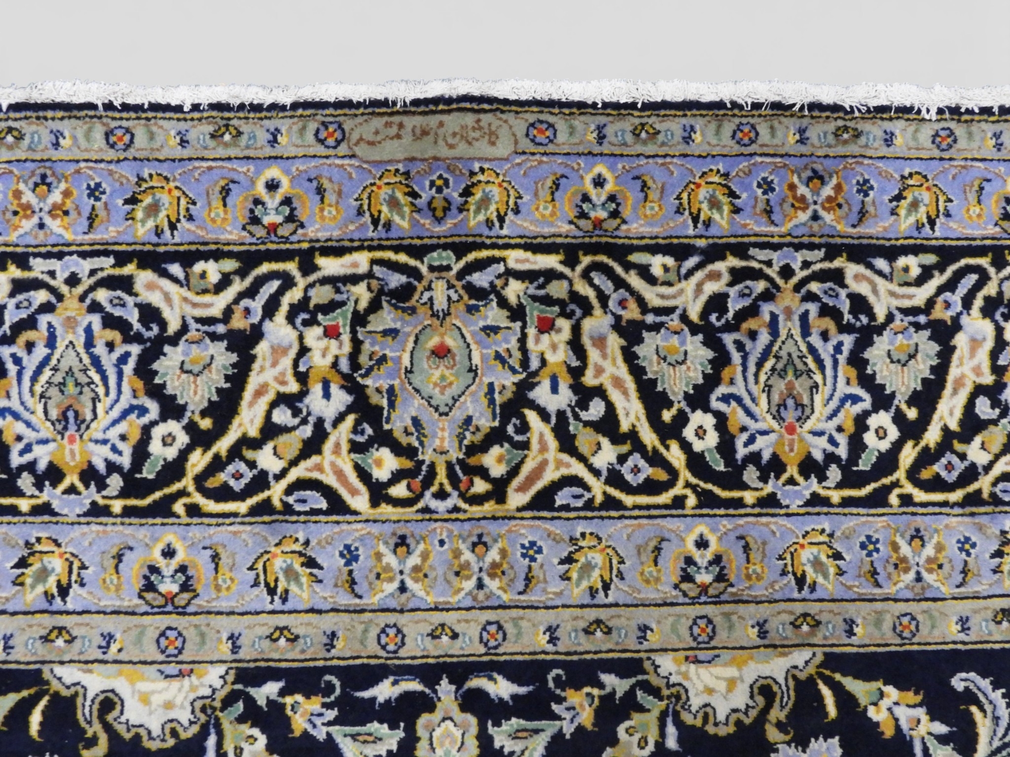 A DARK BLUE GROUND KASHAN RUGwith all over floral/foliate patterned ...
