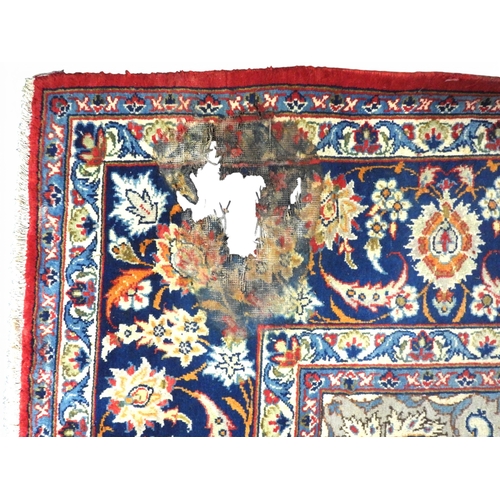 1 - A terracotta ground Persian rug with cream and blue sunburst central medallion and matching spandrel... 