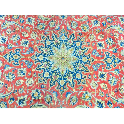 1 - A terracotta ground Persian rug with cream and blue sunburst central medallion and matching spandrel... 