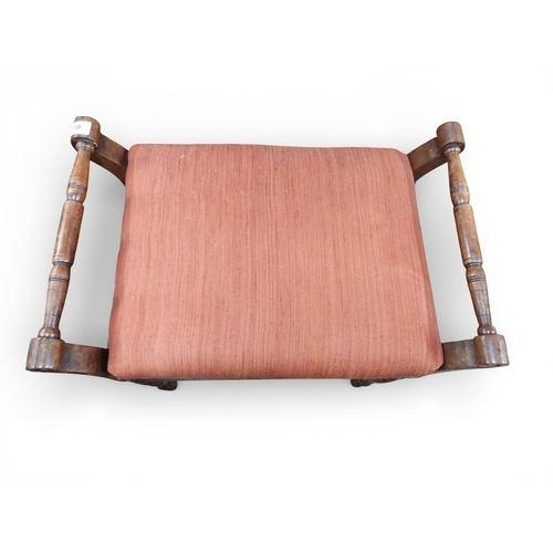 10 - An early 20th century walnut framed piano stool with terracotta upholstered hinged seat on turned su... 