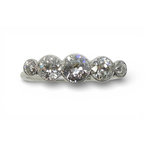 2722 - A FIVE STONE DIAMOND RINGset with five old cut diamonds, in a delicate bright white metal  mill-grai... 