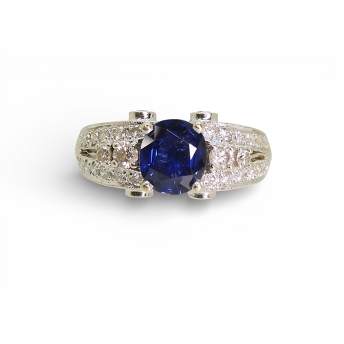 2723 - A SAPPHIRE AND DIAMOND RINGmounted in 18k white gold, set with an oval cut blue sapphire of approx 7... 