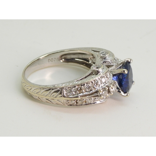 2723 - A SAPPHIRE AND DIAMOND RINGmounted in 18k white gold, set with an oval cut blue sapphire of approx 7... 