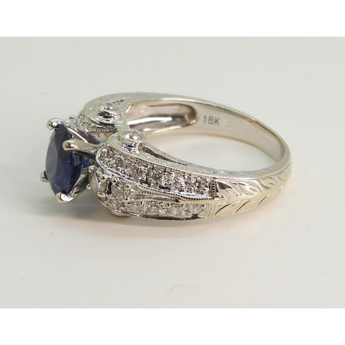 2723 - A SAPPHIRE AND DIAMOND RINGmounted in 18k white gold, set with an oval cut blue sapphire of approx 7... 