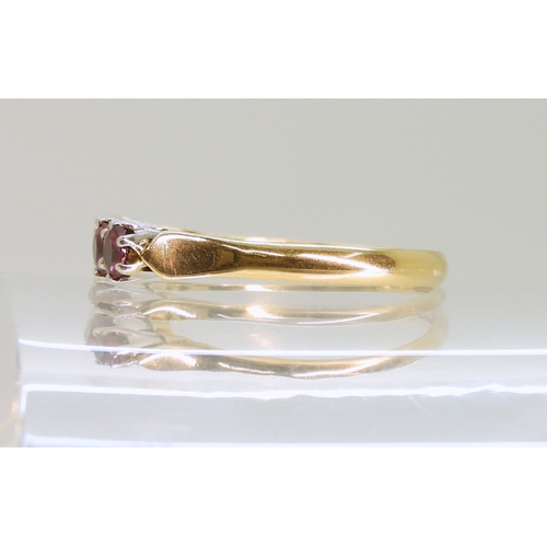 2726 - A RUBY ETERNITY RINGwith a yellow and white 18ct gold mount, set with five rubies each approx 3.5mm.... 