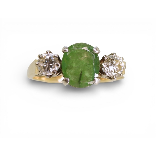 2728 - AN EMERALD & DIAMOND RINGthe 9ct yellow and white gold three stone mount is set with an oval cut... 