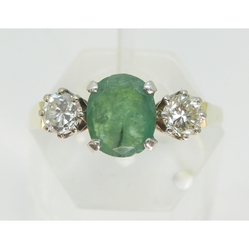 2728 - AN EMERALD & DIAMOND RINGthe 9ct yellow and white gold three stone mount is set with an oval cut... 