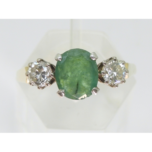2728 - AN EMERALD & DIAMOND RINGthe 9ct yellow and white gold three stone mount is set with an oval cut... 