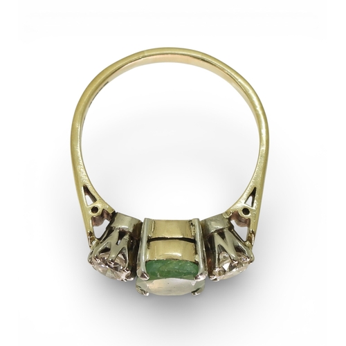 2728 - AN EMERALD & DIAMOND RINGthe 9ct yellow and white gold three stone mount is set with an oval cut... 