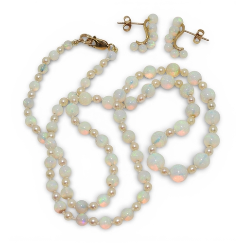 2729 - A SUITE OF OPAL JEWELSto include a pair of creole earrings each with six graduated opal beads on a 1... 