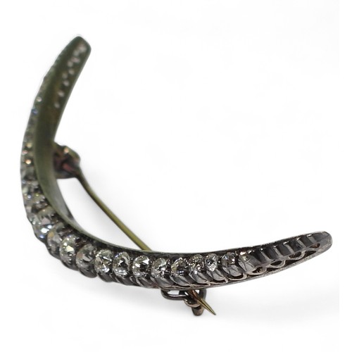 2754 - A VICTORIAN DIAMOND CRESCENT MOON BROOCHthe yellow and white metal galleried mount is set with estim... 