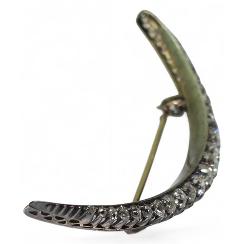 2754 - A VICTORIAN DIAMOND CRESCENT MOON BROOCHthe yellow and white metal galleried mount is set with estim... 