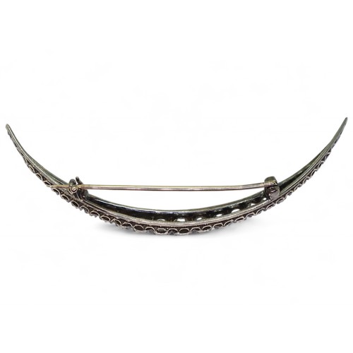 2754 - A VICTORIAN DIAMOND CRESCENT MOON BROOCHthe yellow and white metal galleried mount is set with estim... 