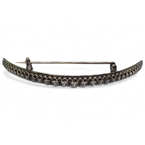 2754 - A VICTORIAN DIAMOND CRESCENT MOON BROOCHthe yellow and white metal galleried mount is set with estim... 
