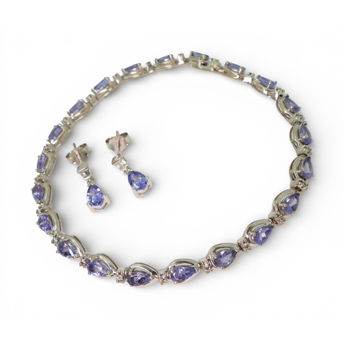 2735 - A SUITE OF TANZANITE & DIAMOND JEWELSa 14k white gold pear shaped tanzanite and diamond bracelet... 
