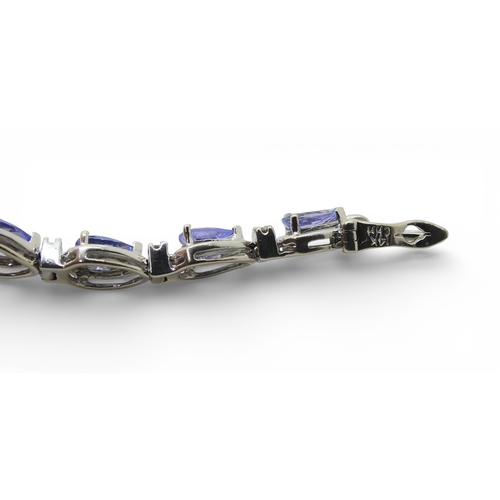 2735 - A SUITE OF TANZANITE & DIAMOND JEWELSa 14k white gold pear shaped tanzanite and diamond bracelet... 