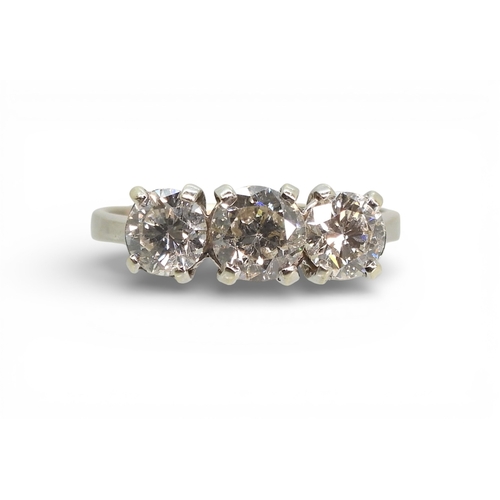 2736 - A THREE STONE DIAMOND RINGthe mount in 9ct white gold and set with three brilliant cut diamonds with... 