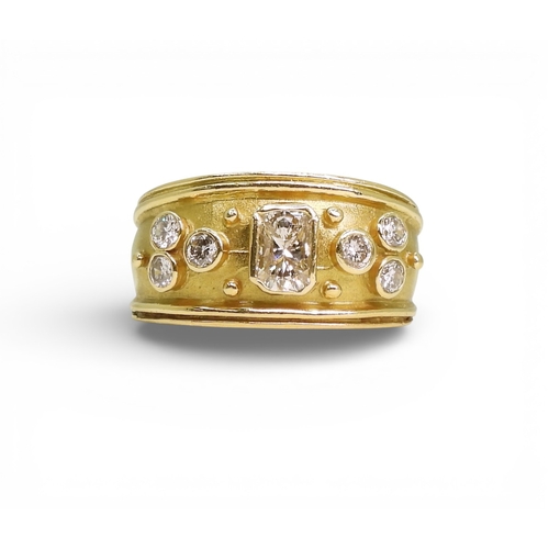 2738 - A DIAMOND SET WIDE BAND RINGthe 18ct gold mount is set with an oblong princess cut diamond of estima... 