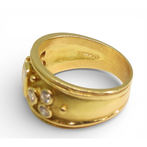 2738 - A DIAMOND SET WIDE BAND RINGthe 18ct gold mount is set with an oblong princess cut diamond of estima... 