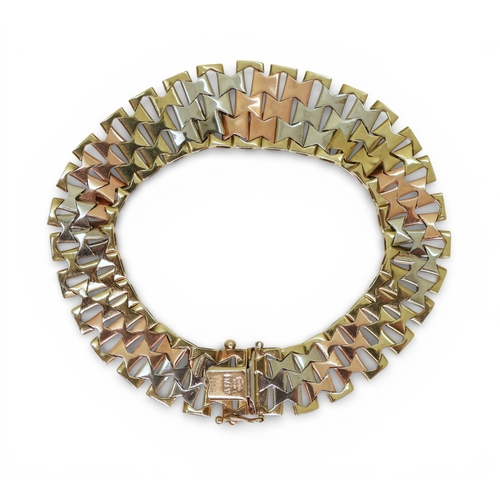 2741 - AN ITALIAN MADE 9CT GOLD TRICOLOUR BRACELETof double tapered form with bark textured links. Length19... 