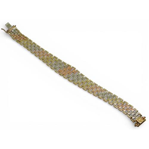 2741 - AN ITALIAN MADE 9CT GOLD TRICOLOUR BRACELETof double tapered form with bark textured links. Length19... 