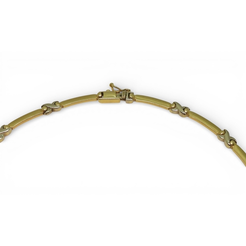 2745 - A DIAMOND FLOWER NECKLACEmade in 14k yellow and white gold with baton and kiss shaped links, with a ... 