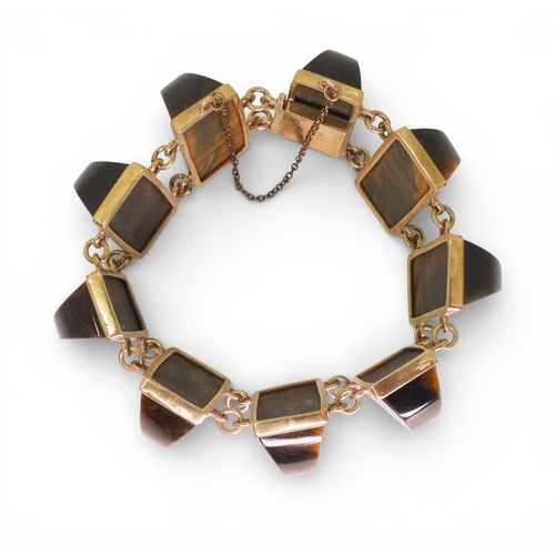 2748 - A BLUE & GOLDEN TIGERSEYE BRACELETof abstract form, set with semi circular facet cut tigerseye g... 