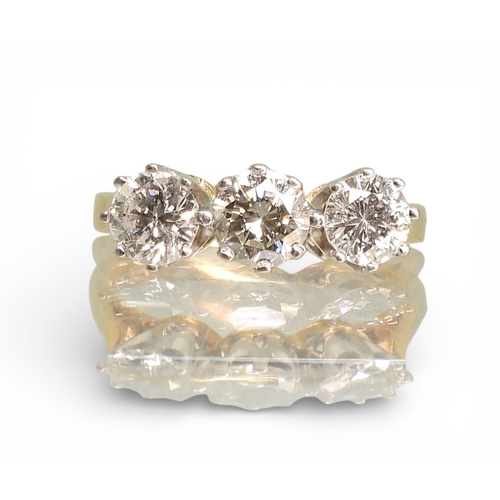 2749 - A THREE STONE DIAMOND RINGthe mount in 18ct yellow and white gold and set with three diamonds with a... 