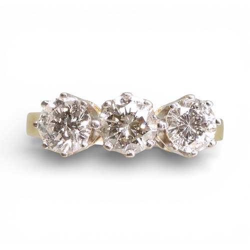2749 - A THREE STONE DIAMOND RINGthe mount in 18ct yellow and white gold and set with three diamonds with a... 