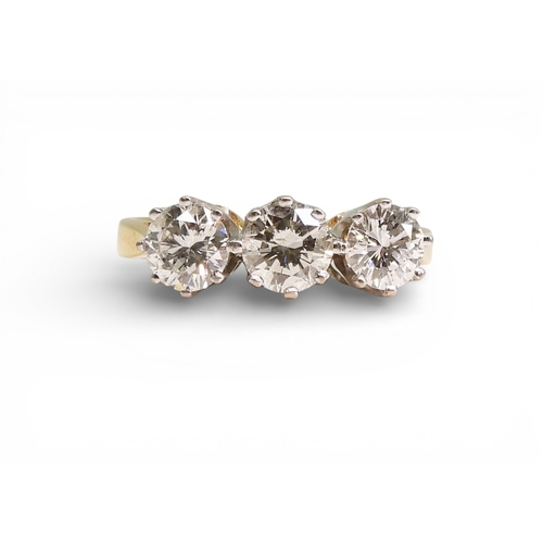 2749 - A THREE STONE DIAMOND RINGthe mount in 18ct yellow and white gold and set with three diamonds with a... 