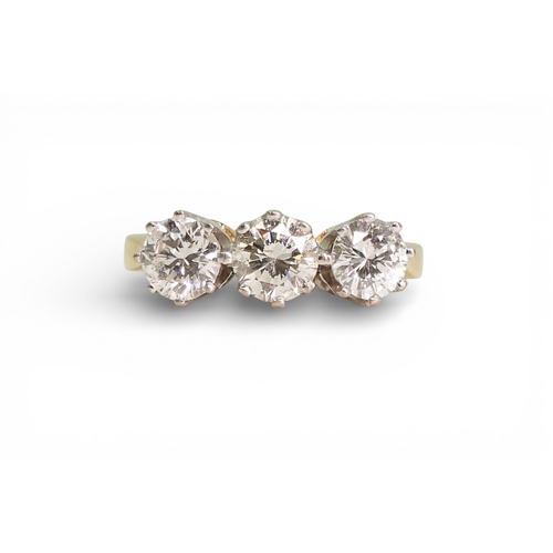 2749 - A THREE STONE DIAMOND RINGthe mount in 18ct yellow and white gold and set with three diamonds with a... 