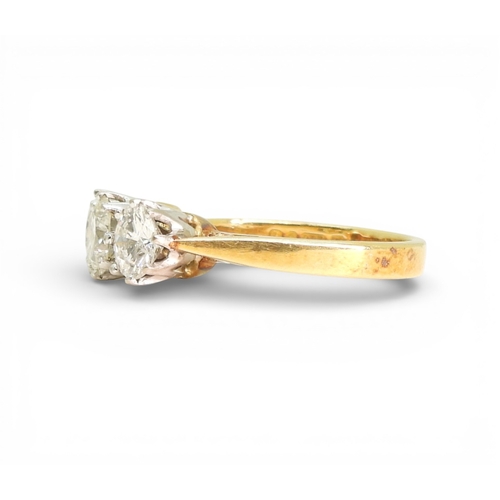 2749 - A THREE STONE DIAMOND RINGthe mount in 18ct yellow and white gold and set with three diamonds with a... 