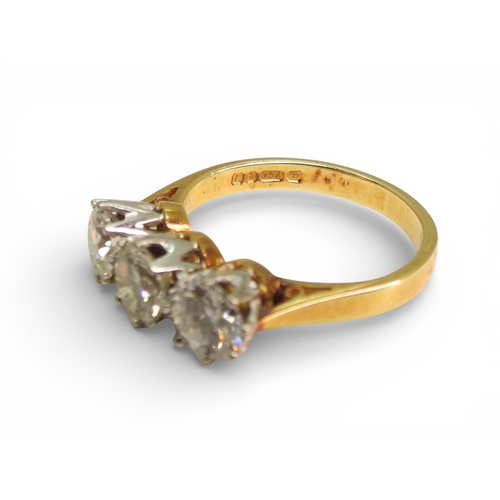 2749 - A THREE STONE DIAMOND RINGthe mount in 18ct yellow and white gold and set with three diamonds with a... 