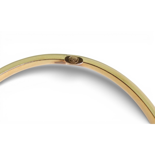 2751 - A CLASSIC PLAIN GOLD BANGLEmade in 14k gold, with gentle domed interior and exterior, the tongue of ... 