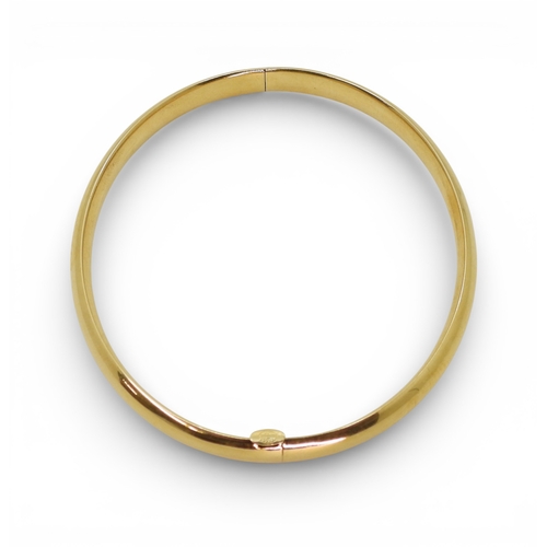 2751 - A CLASSIC PLAIN GOLD BANGLEmade in 14k gold, with gentle domed interior and exterior, the tongue of ... 