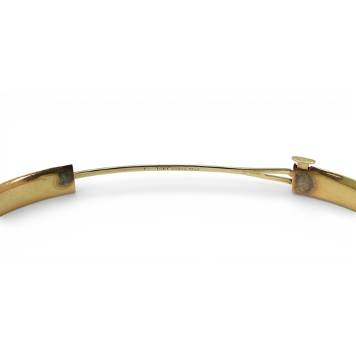 2751 - A CLASSIC PLAIN GOLD BANGLEmade in 14k gold, with gentle domed interior and exterior, the tongue of ... 