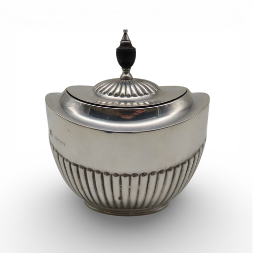 902 - A silver tea caddy, by William Hutton & Sons, London 1907, the body party-fluted, 201gms
