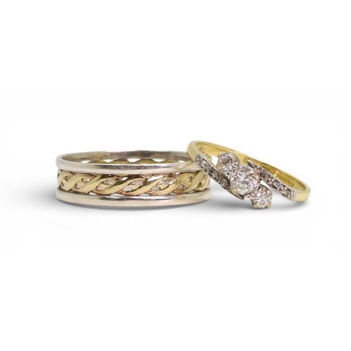 704 - A vintage 18ct gold three stone diamond ring, size O, weight 2.2gms and a silver and 9ct gold weddin... 