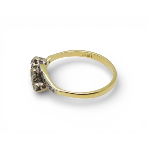 704 - A vintage 18ct gold three stone diamond ring, size O, weight 2.2gms and a silver and 9ct gold weddin... 
