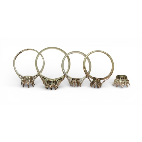 719 - Four bright white metal ring blanks, one stamped PLAT one stamped 18ct and PLAT, and a stone setting... 