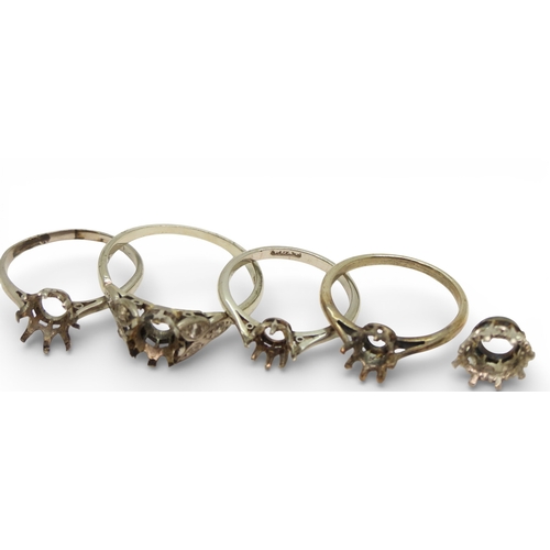719 - Four bright white metal ring blanks, one stamped PLAT one stamped 18ct and PLAT, and a stone setting... 