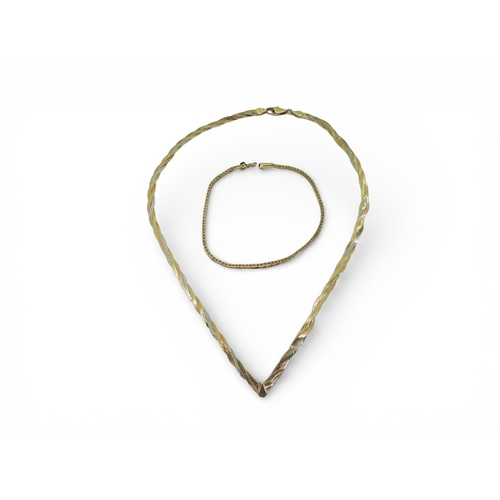 787 - A 9ct gold tri colour gold bracelet, length 18cm, and a 9ct tricolour gold 'V' shaped ribbon necklac... 