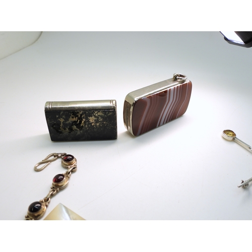 872 - Three 1887 enamelled coins, two white metal mounted agate vestas one in the shape of a book inlaid w... 