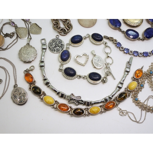 879 - A collection of silver and white metal jewellery to include bracelets set with lapis lazuli, and amb... 